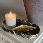 Load image into Gallery viewer, ellipse marble stone tray catchall with candle and vintage ash tray on design books
