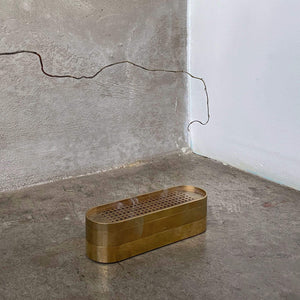 brass incense burner, incense burner, concrete floor