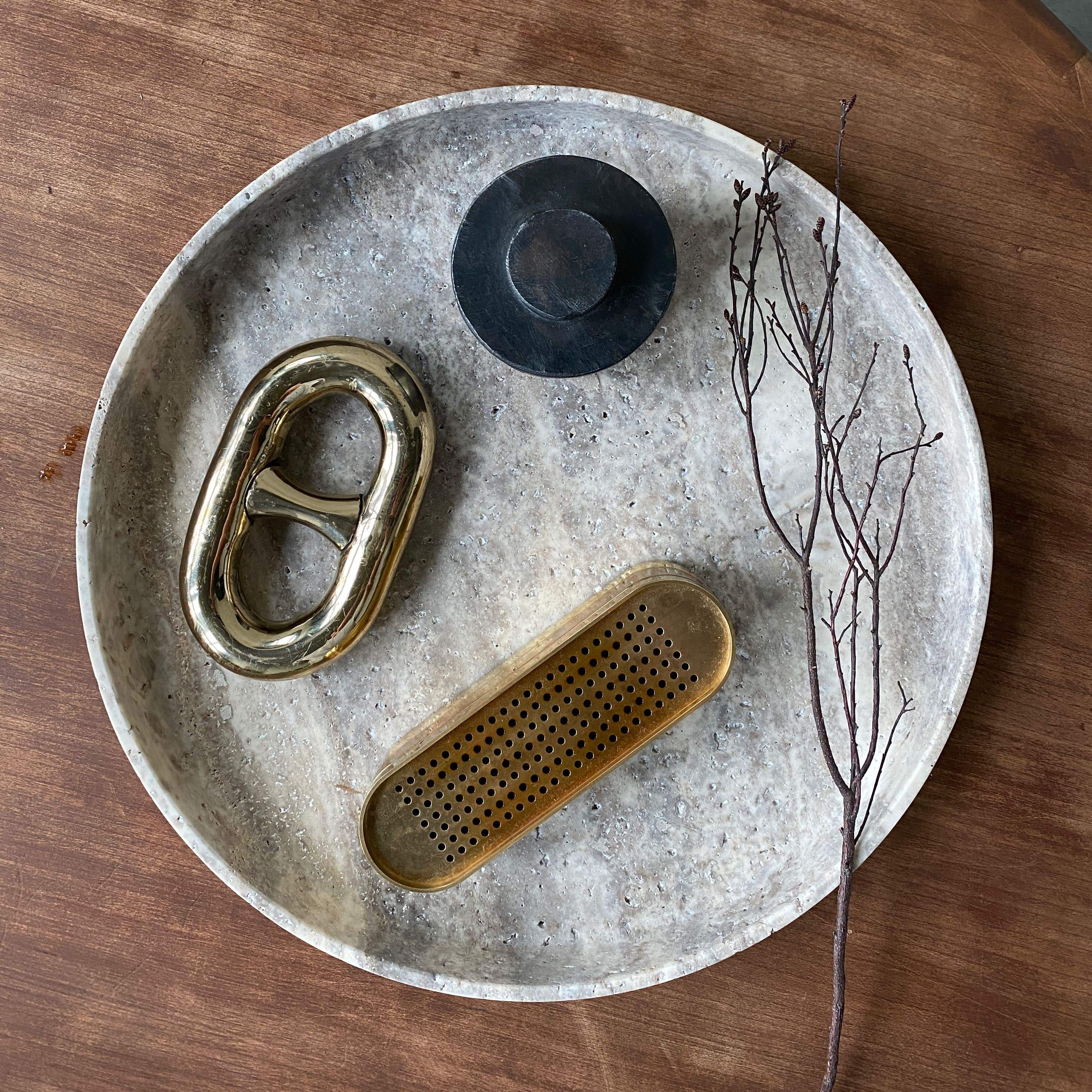 travertine stone round tray with incense burner and decor and accessories on wood table